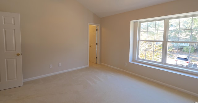 107 Pawleys Place Dr Unit 107, Pawleys Island, SC 29585 - empty room with plenty of natural light, lofted ceiling, baseboards, and light carpet