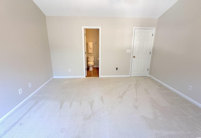 107 Pawleys Place Dr Unit 107, Pawleys Island, SC 29585 - unfurnished bedroom featuring baseboards, light carpet, and ensuite bathroom