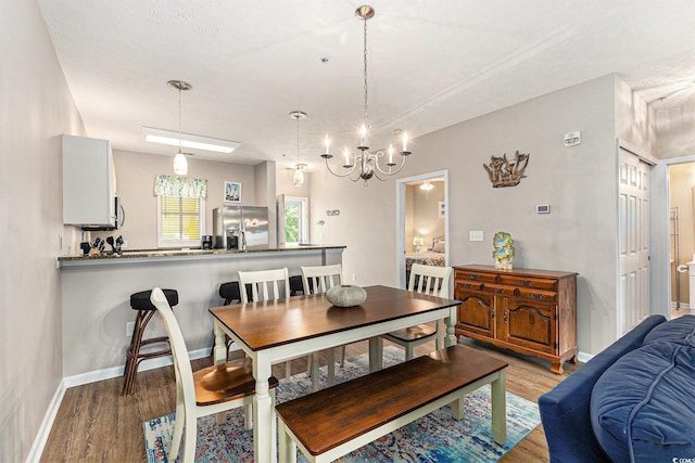 601 Hillside Dr N Unit 2135, North Myrtle Beach, SC 29582 - dining area with light wood finished floors, a chandelier, and baseboards