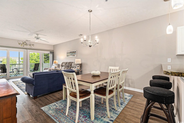 601 Hillside Dr N Unit 2135, North Myrtle Beach, SC 29582 - dining area with a ceiling fan, dark wood-style flooring, a chandelier, baseboards, and a textured ceiling