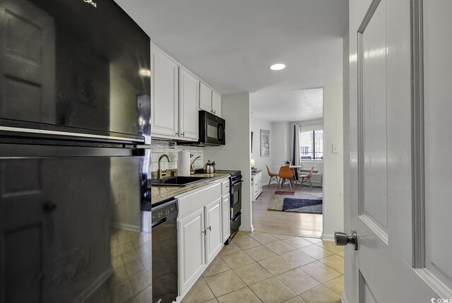 2001 S Ocean Blvd Unit 721, Myrtle Beach, SC 29577 - kitchen featuring black appliances, a sink, white cabinets, light tile patterned floors, and recessed lighting
