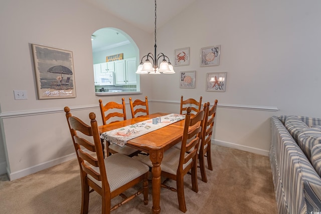 6203 Catalina Dr Unit 1333, North Myrtle Beach, SC 29582 - dining room with light carpet, a chandelier, baseboards, lofted ceiling, and arched walkways