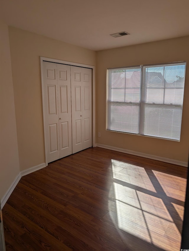 281 Palmetto Glen Dr, Myrtle Beach, SC 29588 - unfurnished bedroom featuring wood finished floors, baseboards, and a closet