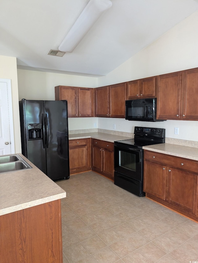 281 Palmetto Glen Dr, Myrtle Beach, SC 29588 - kitchen featuring black appliances, lofted ceiling, light countertops, brown cabinets, and a sink