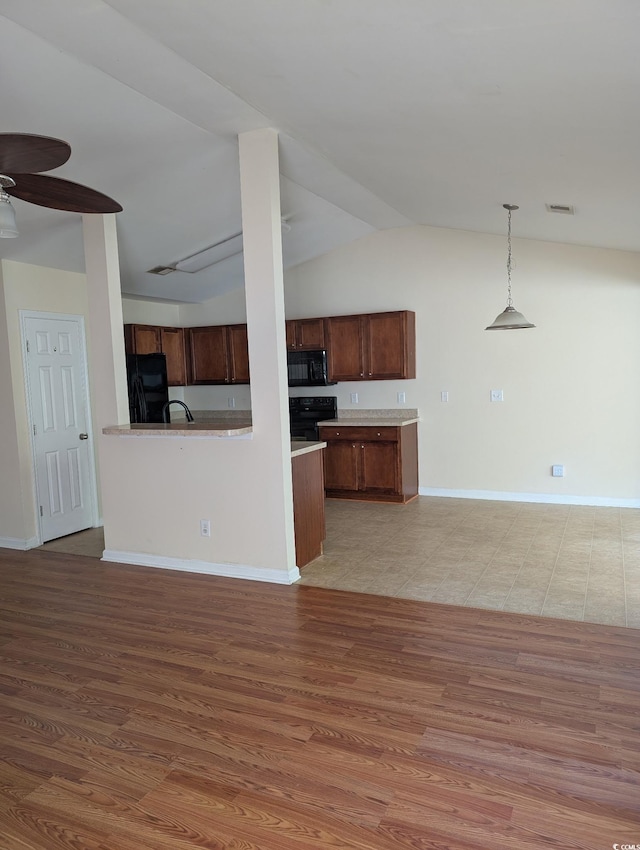 281 Palmetto Glen Dr, Myrtle Beach, SC 29588 - kitchen featuring black appliances, ceiling fan, lofted ceiling, open floor plan, and decorative light fixtures