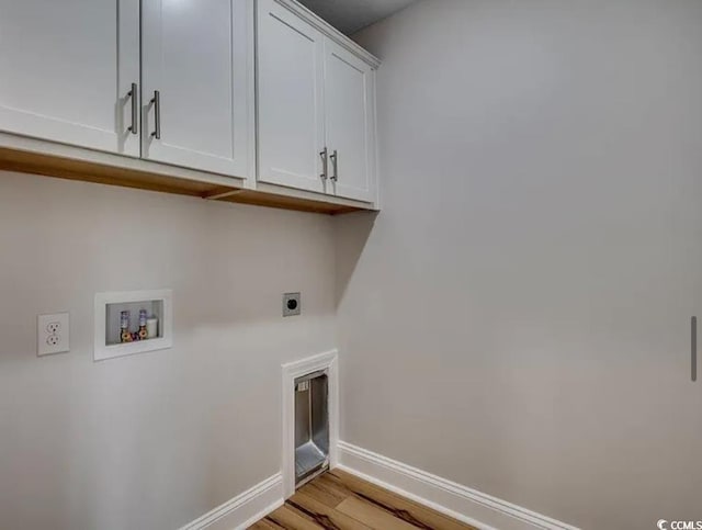 2599 Woodcreek Ln, Conway, SC 29527 - laundry area featuring hookup for an electric dryer, cabinet space, washer hookup, baseboards, and light wood finished floors