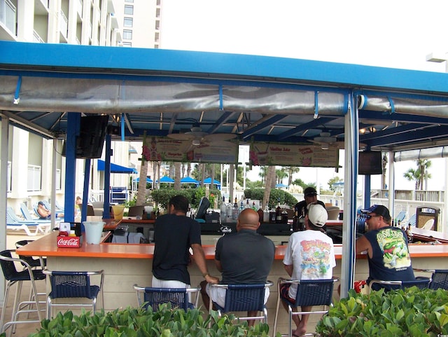 5300 N Ocean Blvd Unit 306, Myrtle Beach, SC 29577 - view of patio / terrace with a ceiling fan and a bar