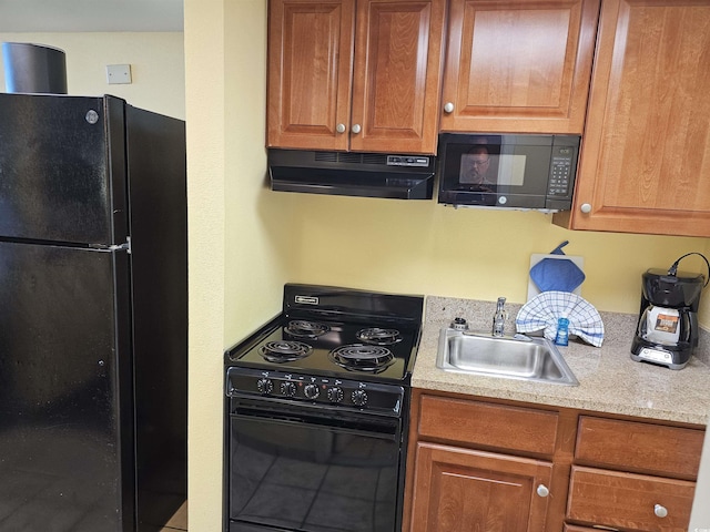 5300 N Ocean Blvd Unit 306, Myrtle Beach, SC 29577 - kitchen featuring under cabinet range hood, black appliances, a sink, light countertops, and brown cabinetry