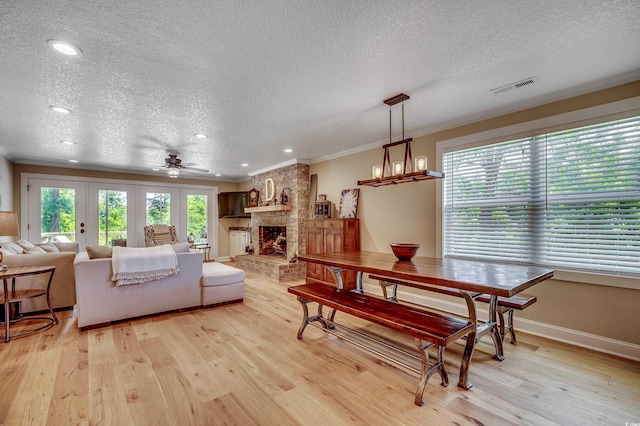 112 Blue Gull Dr, Conway, SC 29526 - living area with a textured ceiling, ornamental molding, light wood-type flooring, ceiling fan, and a fireplace