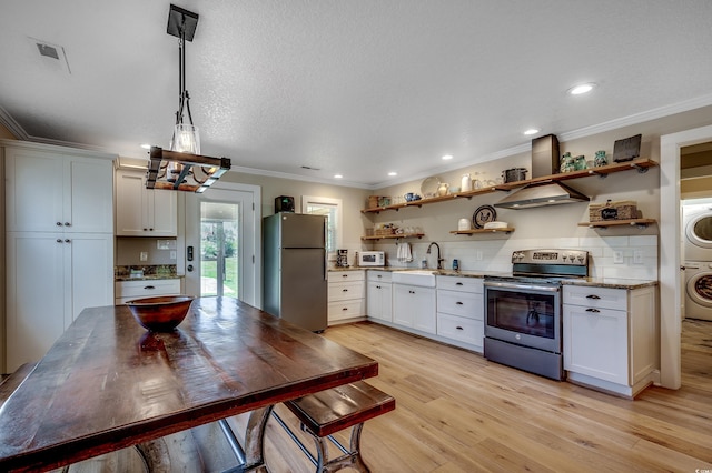 112 Blue Gull Dr, Conway, SC 29526 - kitchen featuring stainless steel range with electric stovetop, freestanding refrigerator, open shelves, stacked washer / dryer, and ornamental molding
