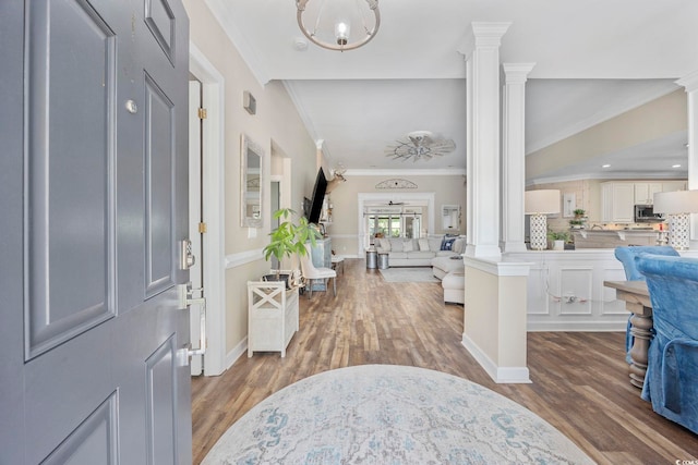 7005 Wellesley Ct, Murrells Inlet, SC 29576 - entryway with decorative columns, wood finished floors, and crown molding
