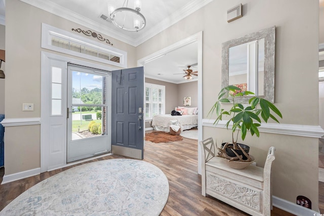 7005 Wellesley Ct, Murrells Inlet, SC 29576 - foyer with wood finished floors, ornamental molding, a chandelier, and a ceiling fan
