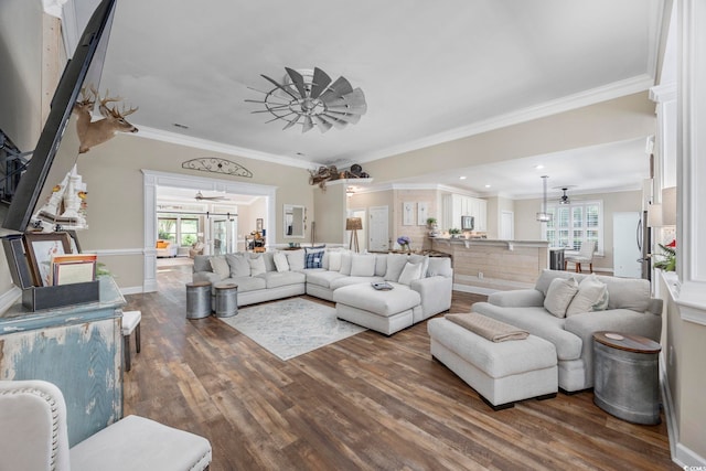 7005 Wellesley Ct, Murrells Inlet, SC 29576 - living area featuring ceiling fan, dark wood finished floors, healthy amount of natural light, and ornamental molding