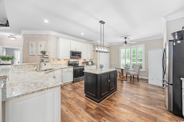 7005 Wellesley Ct, Murrells Inlet, SC 29576 - kitchen featuring stainless steel appliances, white cabinets, decorative backsplash, a ceiling fan, and crown molding
