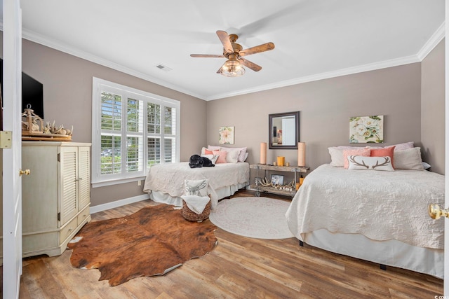 7005 Wellesley Ct, Murrells Inlet, SC 29576 - bedroom featuring wood finished floors, crown molding, and a ceiling fan