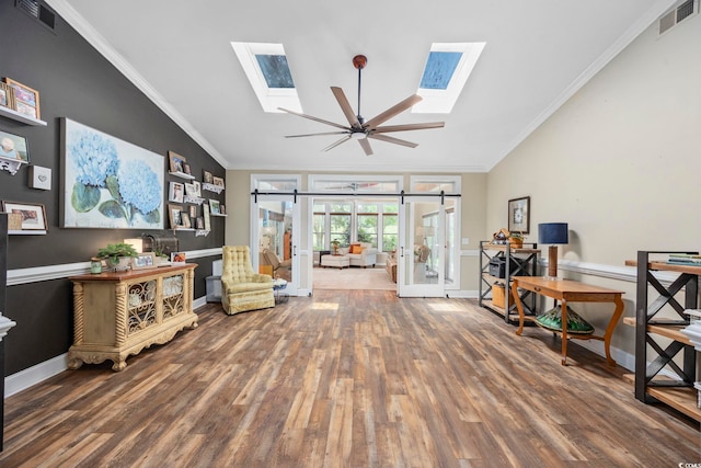 7005 Wellesley Ct, Murrells Inlet, SC 29576 - living area with a skylight, wood finished floors, crown molding, lofted ceiling, and ceiling fan