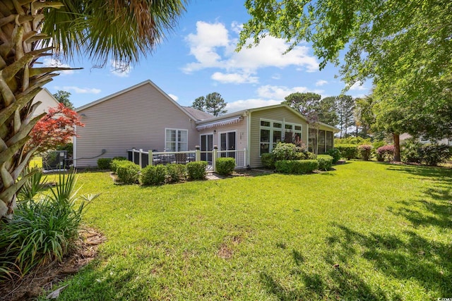 7005 Wellesley Ct, Murrells Inlet, SC 29576 - back of property with a lawn and a sunroom