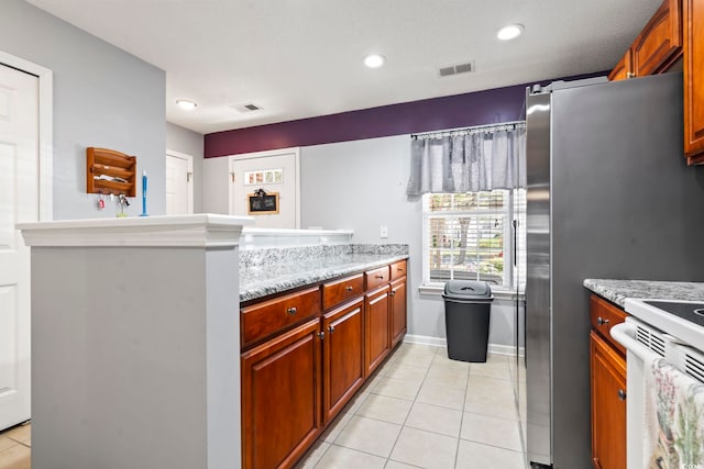 1102 Stanton Pl Unit 1102, Myrtle Beach, SC 29579 - kitchen featuring light tile patterned floors, a peninsula, recessed lighting, white range, and light stone counters