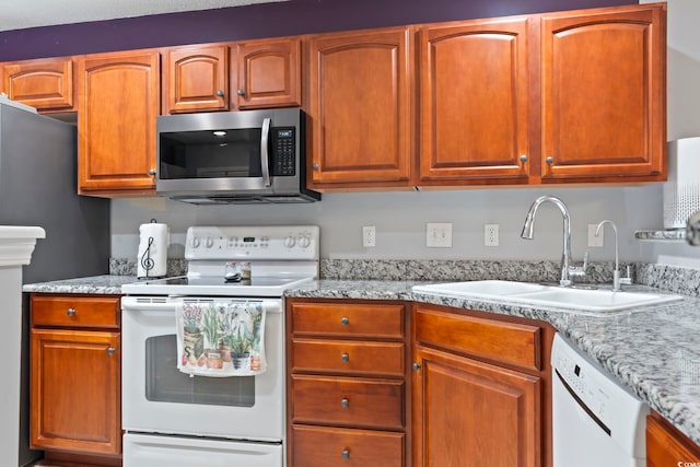 1102 Stanton Pl Unit 1102, Myrtle Beach, SC 29579 - kitchen with white appliances, a sink, light stone countertops, and brown cabinets