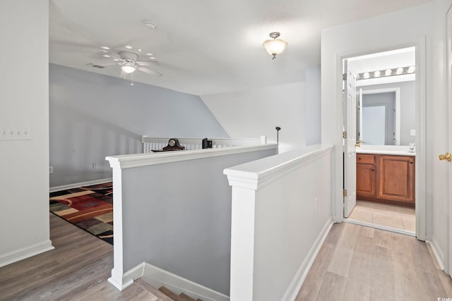 1102 Stanton Pl Unit 1102, Myrtle Beach, SC 29579 - hall featuring an upstairs landing, light wood-style flooring, baseboards, and lofted ceiling