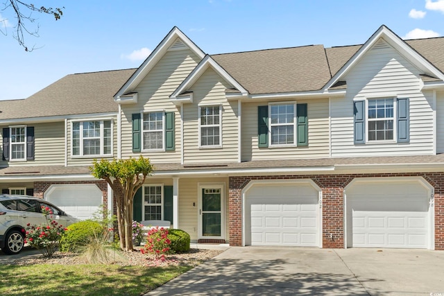 1102 Stanton Pl Unit 1102, Myrtle Beach, SC 29579 - view of property with brick siding, an attached garage, driveway, and a shingled roof