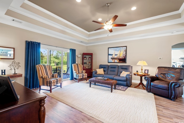 1025 Limpkin Dr, Conway, SC 29526 - living room featuring a raised ceiling, ceiling fan, light wood-style flooring, arched walkways, and recessed lighting