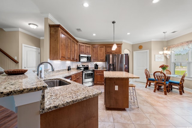 1025 Limpkin Dr, Conway, SC 29526 - kitchen with stainless steel appliances, a breakfast bar, light stone counters, brown cabinets, and recessed lighting