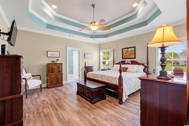 1025 Limpkin Dr, Conway, SC 29526 - bedroom with a tray ceiling, crown molding, light wood-style floors, ensuite bathroom, and a ceiling fan
