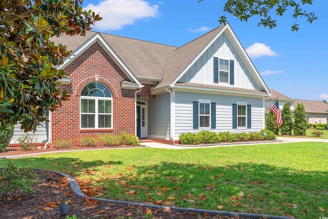 1025 Limpkin Dr, Conway, SC 29526 - traditional home featuring board and batten siding, a front yard, roof with shingles, and brick siding