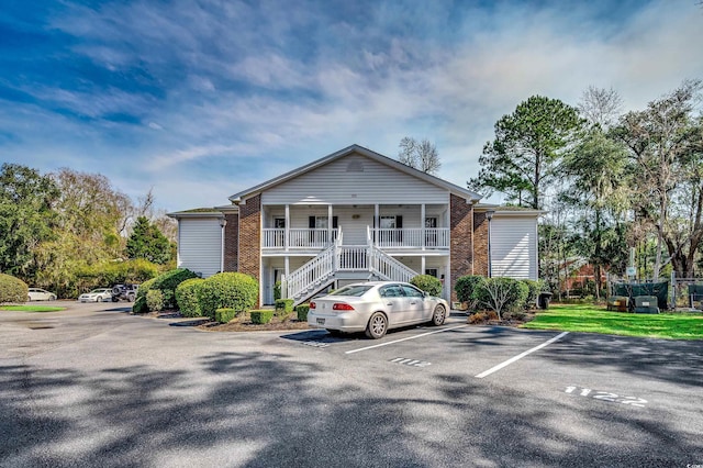 251 Egret Run Ln Unit 1122, Pawleys Island, SC 29585 - view of building exterior featuring stairway and uncovered parking