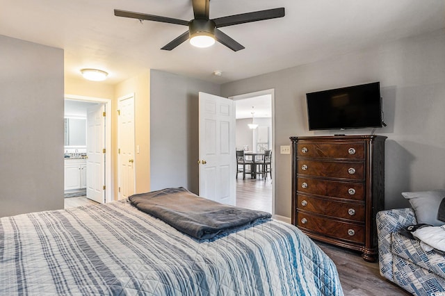 4853 Meadowsweet Dr Unit 1805, Myrtle Beach, SC 29579 - bedroom with wood finished floors, a ceiling fan, a sink, and connected bathroom