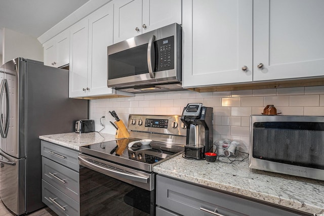 4853 Meadowsweet Dr Unit 1805, Myrtle Beach, SC 29579 - kitchen with stainless steel appliances, gray cabinets, backsplash, light stone countertops, and white cabinets