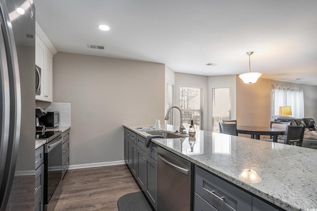 4853 Meadowsweet Dr Unit 1805, Myrtle Beach, SC 29579 - kitchen featuring stainless steel appliances, a sink, light stone countertops, gray cabinets, and dark wood-style floors