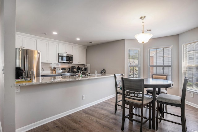 4853 Meadowsweet Dr Unit 1805, Myrtle Beach, SC 29579 - dining room with baseboards, plenty of natural light, dark wood-style floors, and recessed lighting