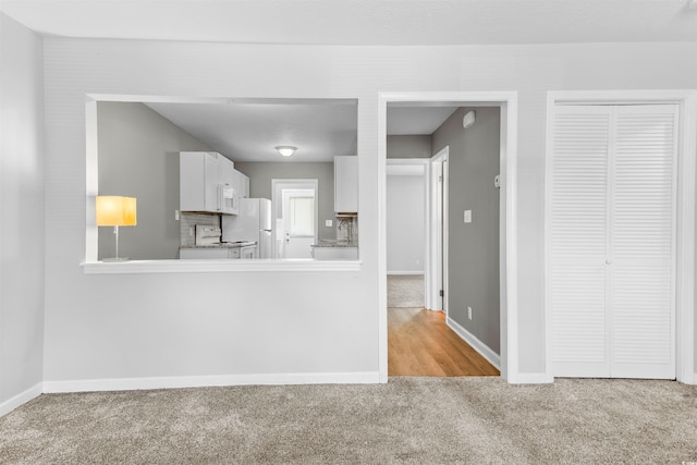 755 Burcale Rd Unit E-3, Myrtle Beach, SC 29579 - kitchen featuring carpet flooring, white appliances, baseboards, and white cabinetry
