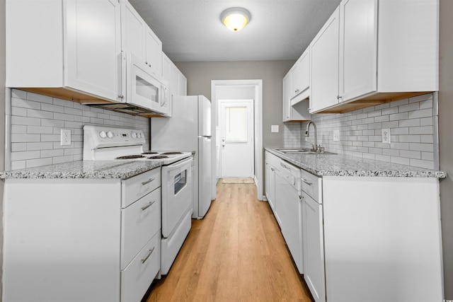 755 Burcale Rd Unit E-3, Myrtle Beach, SC 29579 - kitchen featuring white appliances, a sink, light wood-type flooring, white cabinetry, and tasteful backsplash