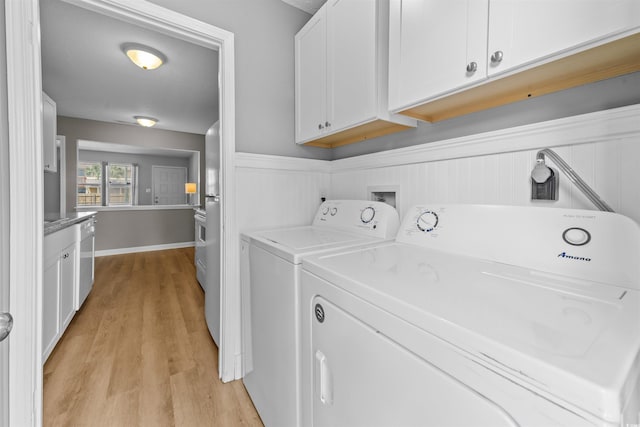 755 Burcale Rd Unit E-3, Myrtle Beach, SC 29579 - laundry area with washer and dryer, light wood-style flooring, cabinet space, and a wainscoted wall