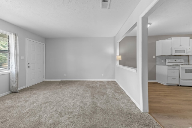 755 Burcale Rd Unit E-3, Myrtle Beach, SC 29579 - unfurnished living room featuring baseboards, carpet, and a textured ceiling