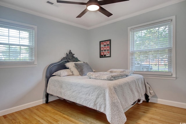 900 47th Ave N, Myrtle Beach, SC 29577 - bedroom featuring multiple windows, light wood-type flooring, baseboards, and crown molding