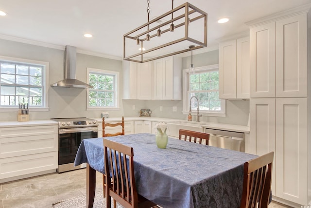 900 47th Ave N, Myrtle Beach, SC 29577 - kitchen featuring appliances with stainless steel finishes, wall chimney range hood, a sink, healthy amount of natural light, and recessed lighting