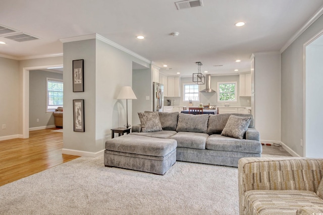 900 47th Ave N, Myrtle Beach, SC 29577 - living room featuring crown molding, light wood-type flooring, recessed lighting, baseboards, and light colored carpet
