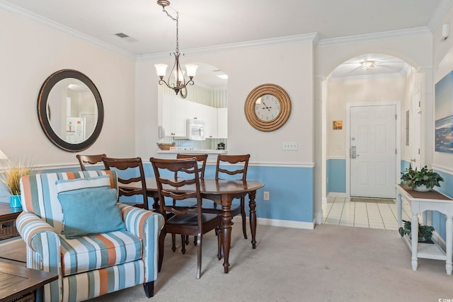 5750 Oyster Catcher Dr Unit 822, North Myrtle Beach, SC 29582 - dining area with arched walkways, a chandelier, ornamental molding, and light colored carpet