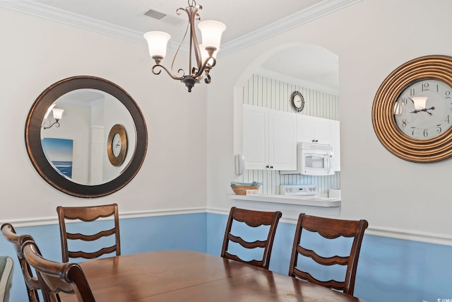 5750 Oyster Catcher Dr Unit 822, North Myrtle Beach, SC 29582 - dining room featuring a chandelier and crown molding