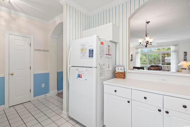 5750 Oyster Catcher Dr Unit 822, North Myrtle Beach, SC 29582 - kitchen with freestanding refrigerator, arched walkways, crown molding, a chandelier, and light countertops
