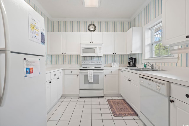 5750 Oyster Catcher Dr Unit 822, North Myrtle Beach, SC 29582 - kitchen with white appliances, wallpapered walls, light countertops, white cabinetry, and ornamental molding