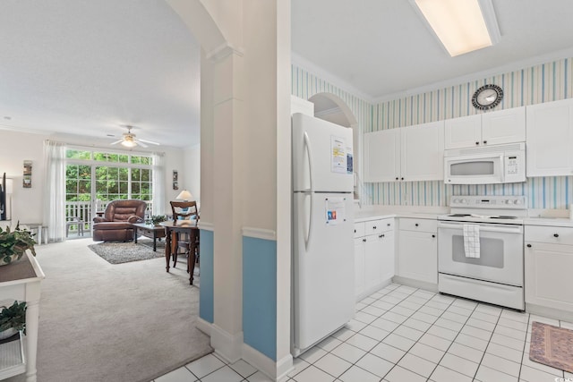 5750 Oyster Catcher Dr Unit 822, North Myrtle Beach, SC 29582 - kitchen featuring white appliances, arched walkways, light countertops, open floor plan, and white cabinets