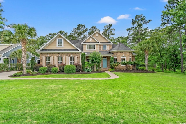 528 Chamberlin Rd, Myrtle Beach, SC 29588 - view of front facade with brick siding and a front lawn