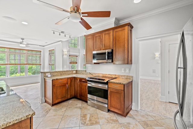 528 Chamberlin Rd, Myrtle Beach, SC 29588 - kitchen featuring stainless steel appliances, a ceiling fan, brown cabinets, ornamental molding, and a peninsula
