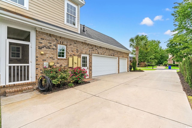 528 Chamberlin Rd, Myrtle Beach, SC 29588 - view of home's exterior with brick siding, driveway, and an attached garage