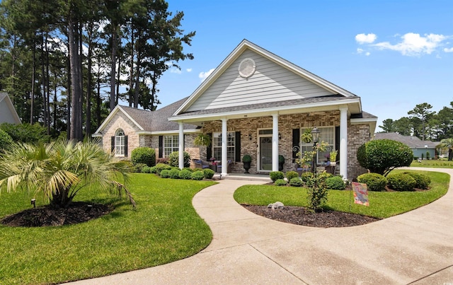 4826 Keel Ct, Myrtle Beach, SC 29579 - view of front of home featuring a front lawn, covered porch, and brick siding